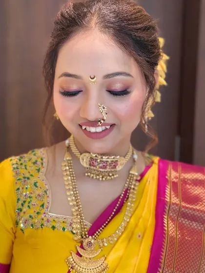 A close-up showing the flawless makeup, including the traditional Chandrakor bindi and nath, essential for a Maharashtrian bride.