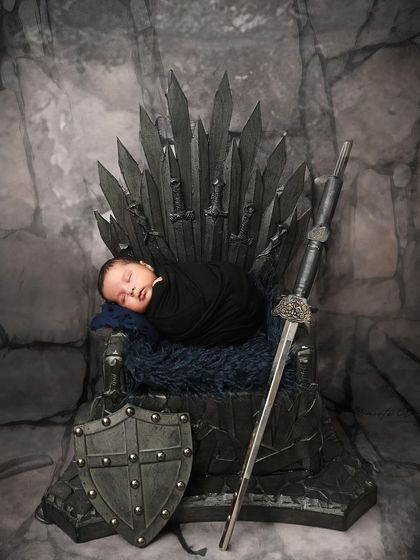 Another take on the epic Game of Thrones theme. This newborn is swaddled in black, sleeping soundly on the iconic Iron Throne.