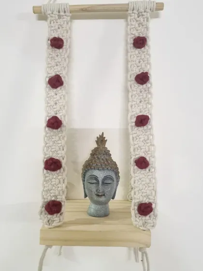 Create a peaceful corner by using the macrame shelf to hold a small Buddha statue or other meaningful objects.