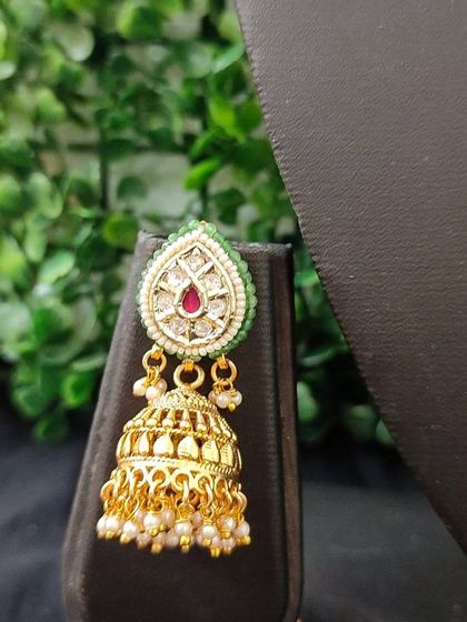 A small, elegant jhumka with a leaf-shaped top, perfect for pre-wedding functions.