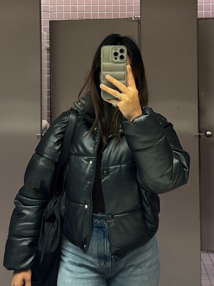 This mirror selfie features a trendy faux leather puffer jacket, a key item for a fall or winter college wardrobe.