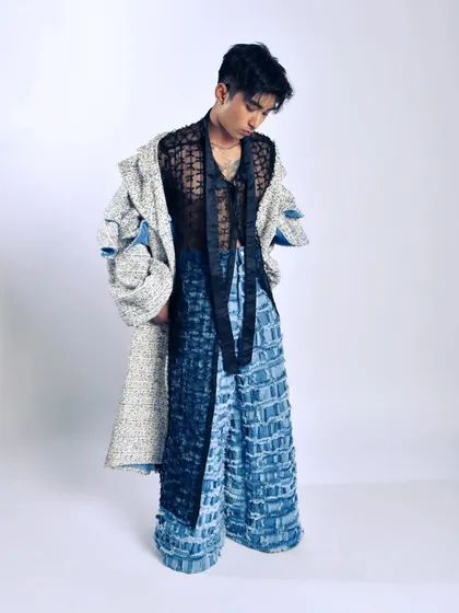 This look is about the complexity of layering different fabrics and textures. The simple white background keeps the focus on the intricate styling.
