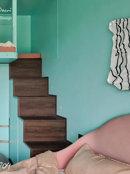 The stairs leading up to the loft in Project 704 are not just stairs; they are also a set of deep storage drawers. Every element in this room was designed to be multi-functional and space-saving.