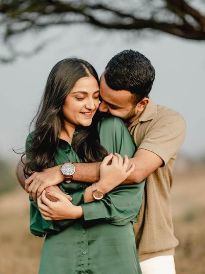 A warm and loving embrace under a tree. This close-up shot is full of genuine affection and tenderness.