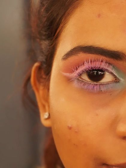 This image shows the full context of the creative eye makeup with pink lashes. It's an example of the detailed, imaginative work I love to practice and perfect for unique editorial projects.