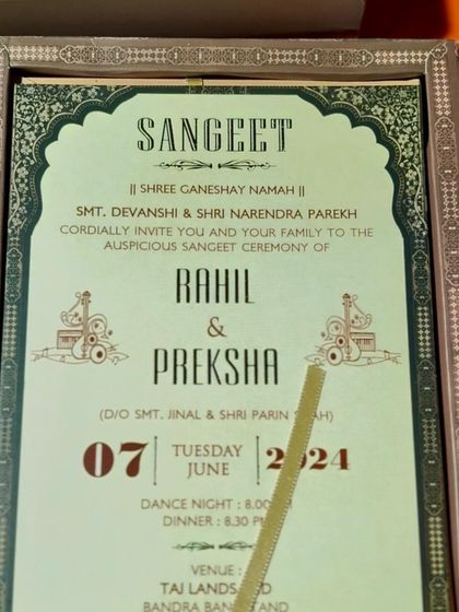 A Sangeet invitation designed with a mint green background and traditional archway border, part of a larger royal suite.