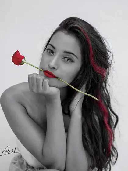 A close-up version of my selective color series. This black and white portrait with pops of red draws all the attention to the model's face, creating a striking and intimate artistic shot.