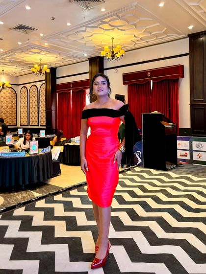 Hosting the auction for the MSCA Kandivali cricket league. The black and white chevron floor and red dress created a dramatic and exciting atmosphere.