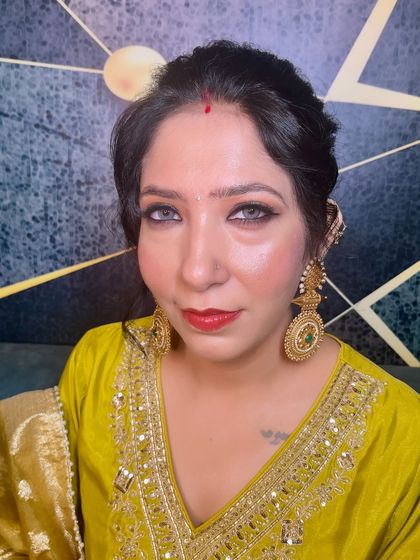 A close-up of this classic Punjabi glam look. The smudged kajal, golden lids, and red lip are timeless and suit all ages.