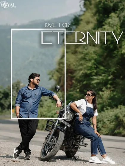 A stylish shot of a couple in denim posing with their bike on a mountain road, titled 'Love for Eternity'.