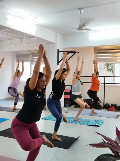 Vrksasana (Tree Pose) is a foundational balancing posture that improves focus and stability. Our students practice with calm concentration.
