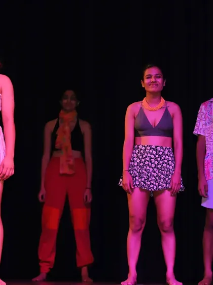 The calm before the storm. Our dancers lined up on stage, ready to explode into movement for a tropical-themed performance piece.