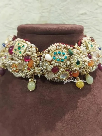 This choker from my Rajwadi Bride collection is a celebration of color and craftsmanship. It features a dense arrangement of pearls and a variety of semi-precious stones, creating a piece that is opulent and full of life.