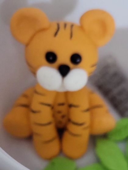 A close-up of the adorable tiger cake topper I made for a jungle-themed birthday party. It's always a joy to create these fun, characterful pieces for children's celebrations.