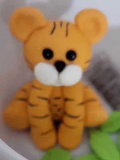 A close-up of the adorable tiger cake topper I made for a jungle-themed birthday party. It's always a joy to create these fun, characterful pieces for children's celebrations.