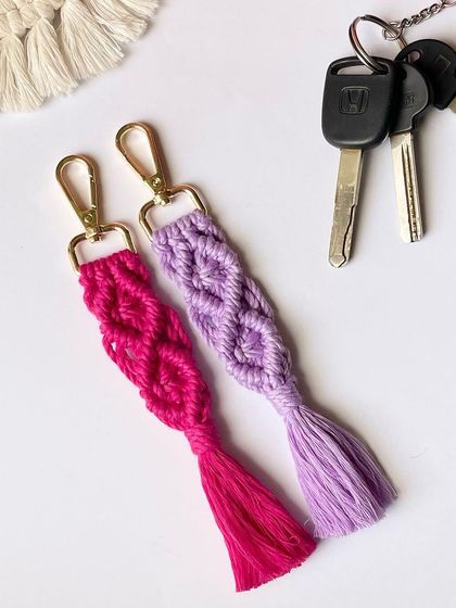 Two keychains in bright pink and purple, attached to a set of keys.