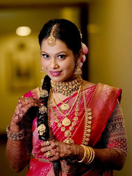 This shot shows the beautiful details of her temple jewelry and the way the makeup complements the richness of her pink Kanjeevaram saree.
