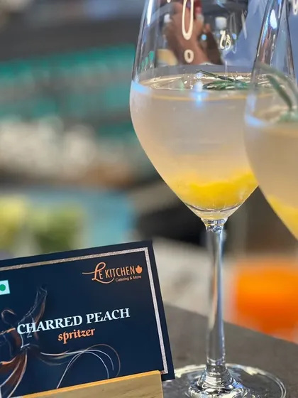 The Charred Peach Spritzer is a sophisticated and smoky drink. The sweetness of the peach is balanced by a hint of char and the herbal notes of rosemary.