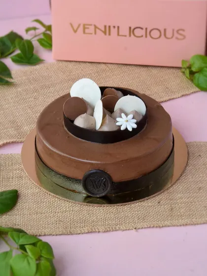 Here’s a call for an extra indulgent Sunday. This is one of our signature chocolate celebration cakes, featuring a smooth, glossy finish and decorated with delicate chocolate discs.