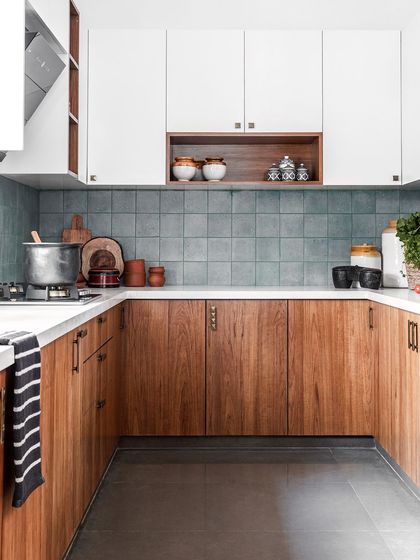 The perfect Indian kitchen: compact yet ergonomic. We chose a timeless palette of classic wood and white, with the only pop of color being the blue-grey tile on the backsplash. It's aesthetic, minimal, and absolutely simple.