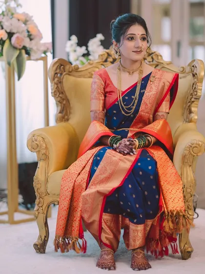 A regal portrait of my Maharashtrian bride Aditi, seated gracefully. Her traditional Nauvari saree, gold jewellery, and the classic bridal glow make for a timeless picture.