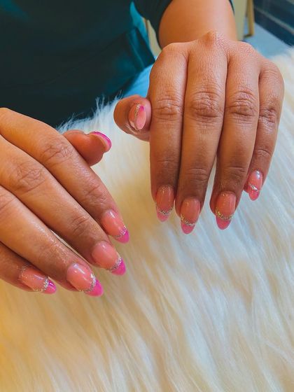 A different angle of the pink ombre and glitter French line design, showing the sparkle on the almond-shaped nails.