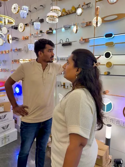 Discussing lighting options with a client in the showroom. We consider everything from chandeliers to subtle accent lights to create the perfect ambiance.