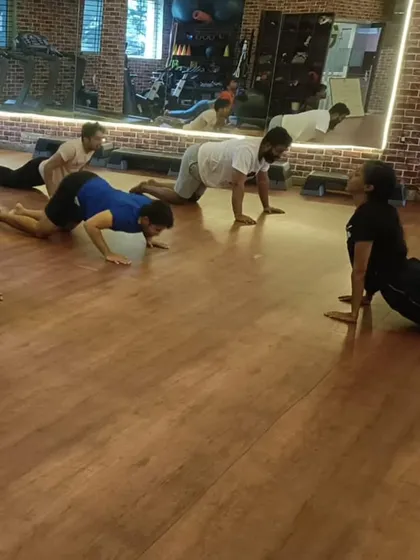 Our group yoga class finding their flow with the Bhujangasana, or cobra pose. These sessions are designed to improve flexibility and core strength, providing a perfect balance to our high-intensity workouts.