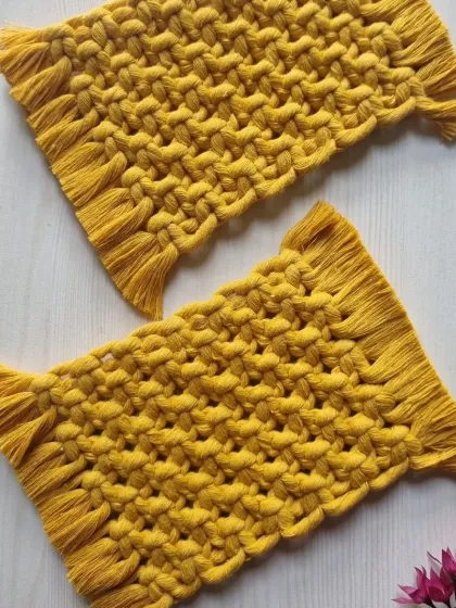 A pair of the rectangular coasters in a vibrant yellow. These 'mug rugs' are a fun and practical alternative to traditional coasters.