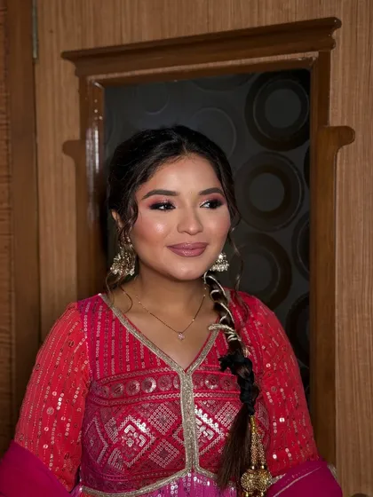 Who needs filters when the glam is this soft? A beautiful pink-toned look with a messy braid for a fresh and youthful vibe, perfect for a daytime wedding event or party.