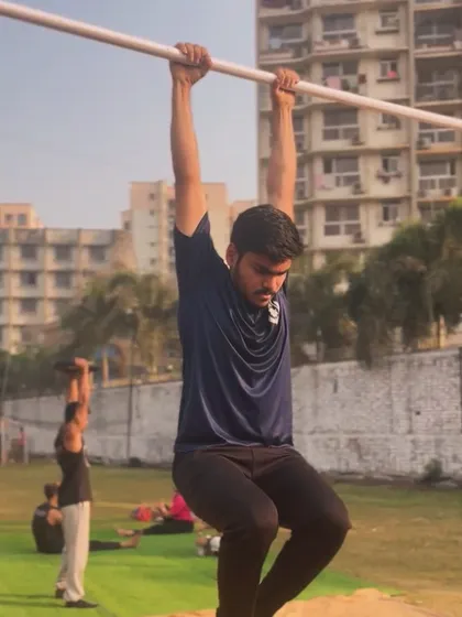 A member working on his tuck-hang, a fundamental step in building the core strength for L-sits and other advanced moves.