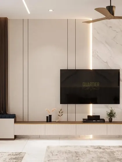 The TV unit in the contemporary master bedroom. The design uses a combination of marble, wood louvers, and clean white surfaces to create a sophisticated and modern entertainment wall.