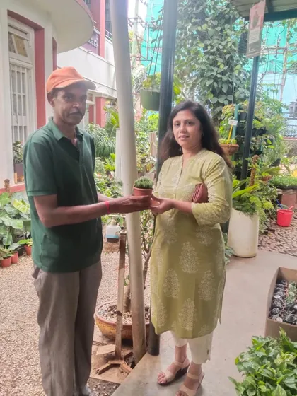 A customer receiving her free plant at our garden center. We believe everyone should have a little green in their life.