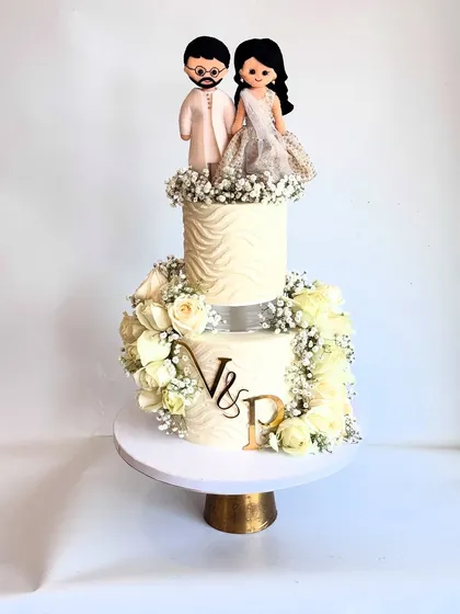 Another angle of the engagement cake, highlighting the textured tiers and the personalized 'V & P' initials.
