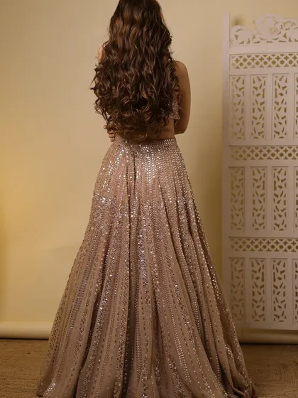A back view showing the beautiful open hairstyle with voluminous curls, perfect for a glamorous evening event.
