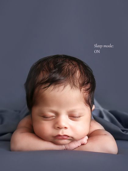 The classic "chin on hands" pose. This adorable position showcases the baby's sweet face and is a favorite among parents for its timeless appeal.