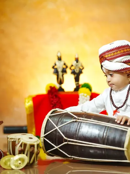 Our little musician tries his hand at the pakhawaj drum, a key instrument in the Varkari tradition.
