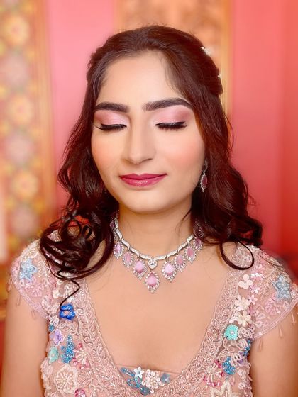 A dreamy close-up of the eye makeup. The soft pink shimmer and perfectly blended shadow create a romantic and ethereal feel for her engagement.