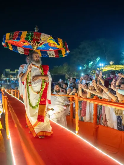 I am walking the path to the Maha Shivratri celebration, greeted by thousands of devotees. This special ramp was built to bring us all closer, making the experience of connection and shared devotion even more intimate and powerful.