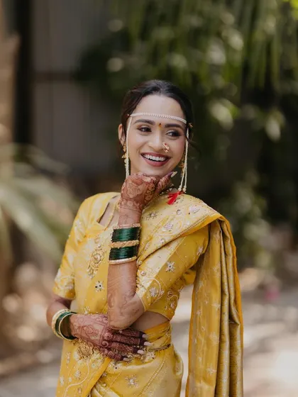 The joy of a Maharashtrian bride on her wedding day. I specialize in creating culturally rich looks, from the traditional 'mundavalya' to the perfect nauvari saree glam, ensuring you look authentic and beautiful.