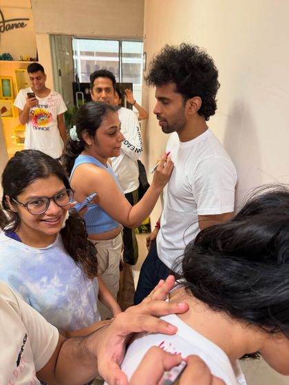 The concentration is real. A student carefully writing a roast on her friend's t shirt. This event was one for the LDI diaries.