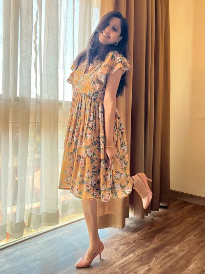 This mustard yellow tiered dress is a must-have for your wardrobe. The floral print and flutter sleeves add effortless charm.