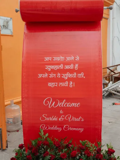 We believe in making a grand first impression. For this wedding, we designed a majestic mandap with cascading strings of red and white flowers, set against the classic architecture of the venue, creating a regal and timeless atmosphere for the ceremony.