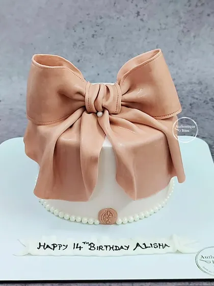 This cake is designed to look exactly like a beautifully wrapped present, complete with an intricate, handcrafted fondant bow. It's a popular choice for birthdays and anniversaries, turning the cake itself into a memorable gift.