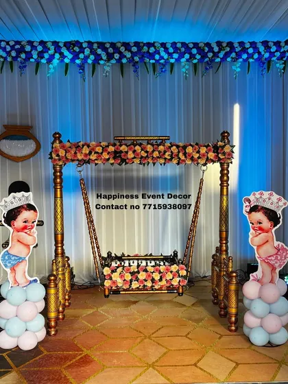 For this naming ceremony, I provided a classic Sankheda jhula decorated with flowers. To add a playful touch for the baby boy and girl, I placed cute prince and princess cutouts on either side of the swing.