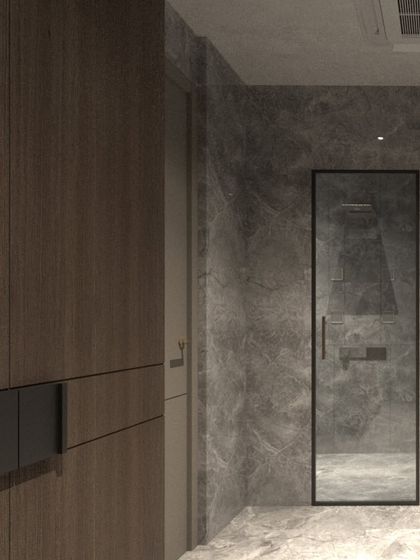 A detail shot of the moody villa bathroom, showing the seamless transition from the wood-clad wardrobe area to the grey stone shower, creating a cohesive material palette.
