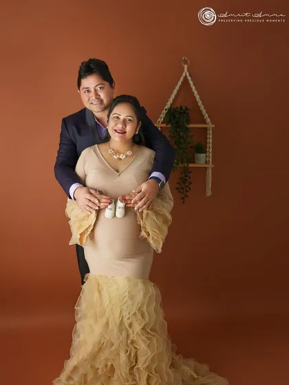 Adding a small prop like these tiny shoes brings so much story to a maternity photo. The reliable wall backdrop system provides a consistent and clean canvas, allowing these little details and emotions to become the focus of the image.