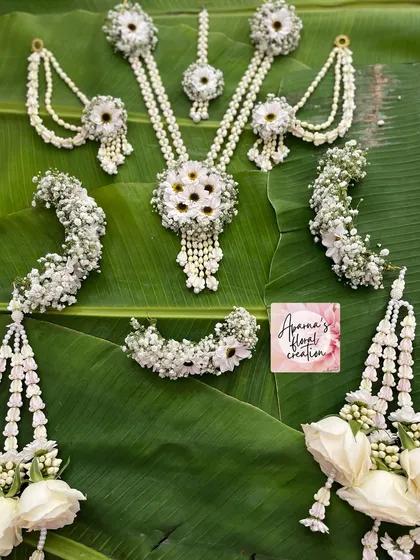 A complete view of the elegant all-white bridal set, which also includes floral kaliree made with white roses.