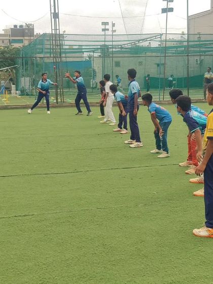 Young players in a ready position during a catching drill. Their focus and effort at this age are what build real champions.