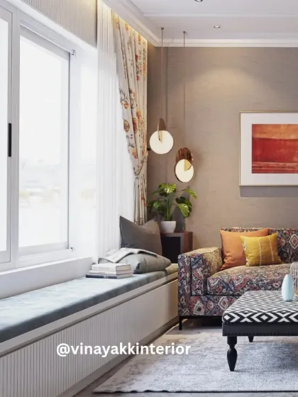 A living room that balances character and comfort. The patterned sofa and ottoman add a pop of personality, while the blush-toned wingback chairs provide elegant seating. The built-in window seat is the perfect nook for reading or enjoying the view.